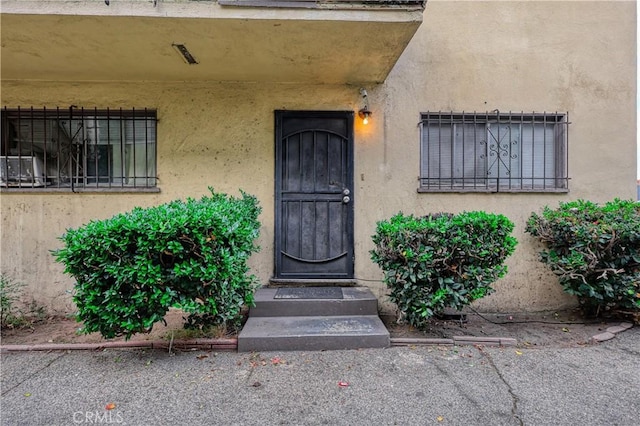 property entrance with stucco siding