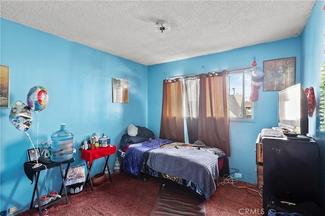 bedroom with a textured ceiling and carpet