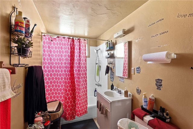 bathroom featuring shower / bath combo with shower curtain and vanity