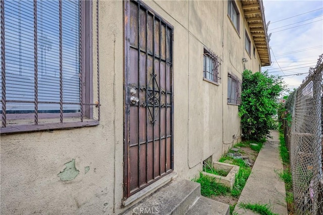 doorway to property with fence