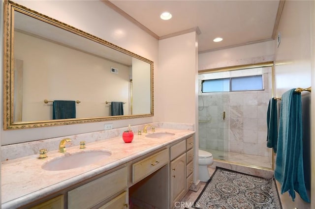 bathroom featuring vanity, toilet, a shower with shower door, and crown molding