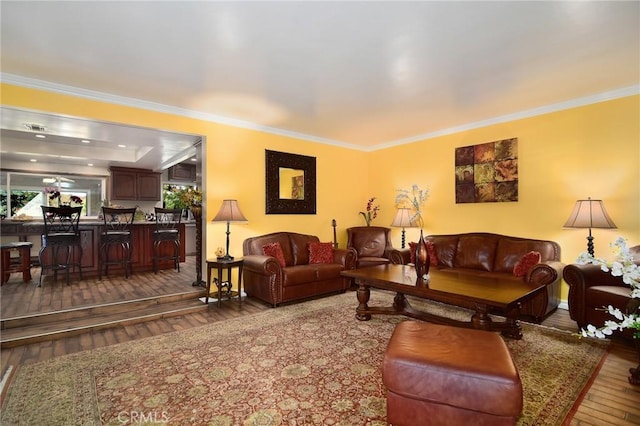 living room with crown molding and hardwood / wood-style floors