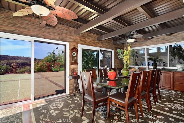 sunroom with beamed ceiling, plenty of natural light, and ceiling fan