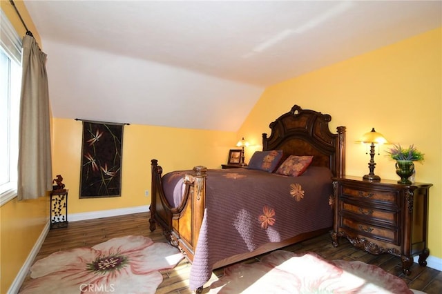 bedroom featuring hardwood / wood-style floors and lofted ceiling