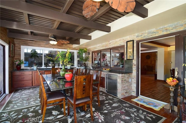 interior space featuring beam ceiling, ceiling fan, and dark hardwood / wood-style floors