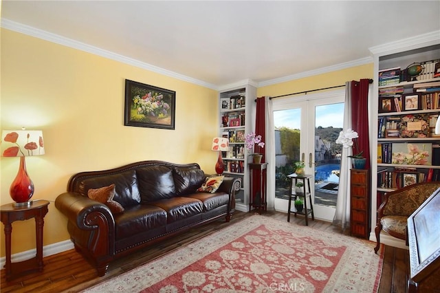 living room with wood-type flooring, built in features, french doors, and crown molding