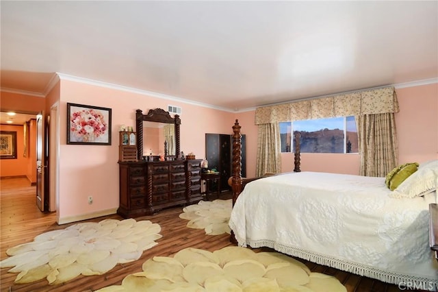 bedroom featuring hardwood / wood-style floors and crown molding