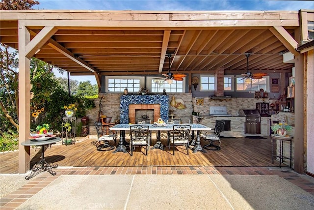 view of patio with grilling area, ceiling fan, and an outdoor fireplace