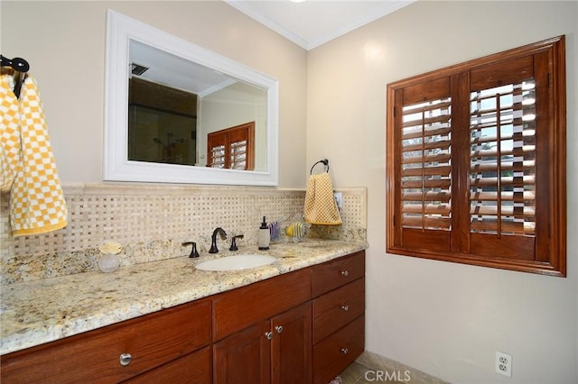 bathroom with vanity, crown molding, and backsplash