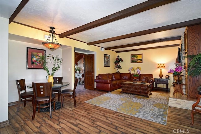 living room with beamed ceiling and dark hardwood / wood-style flooring