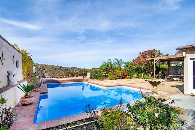 view of swimming pool featuring a mountain view and a patio area