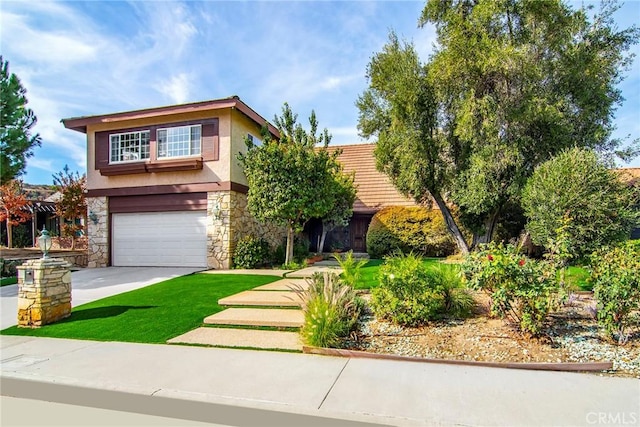 view of front facade with a front yard and a garage