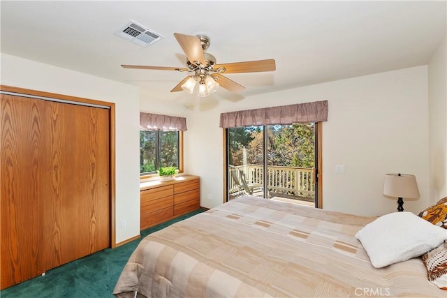 bedroom featuring dark colored carpet, ceiling fan, access to outside, and a closet