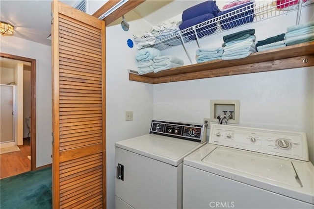 laundry area with separate washer and dryer and carpet