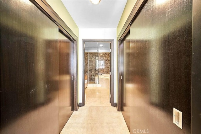 hall with light tile patterned floors