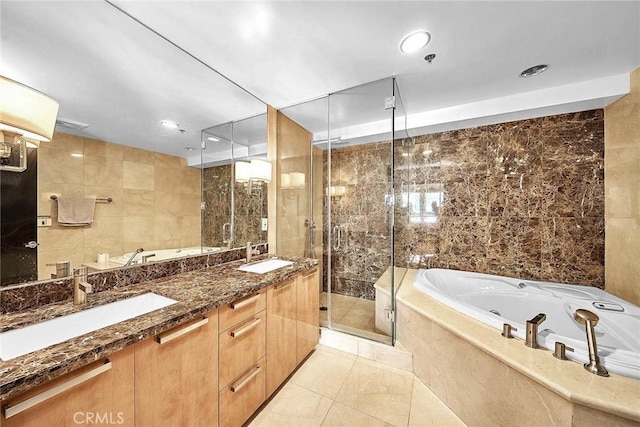 bathroom featuring separate shower and tub, vanity, and tile walls