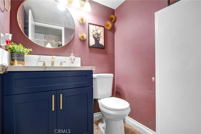 bathroom featuring tile patterned flooring, vanity, and toilet