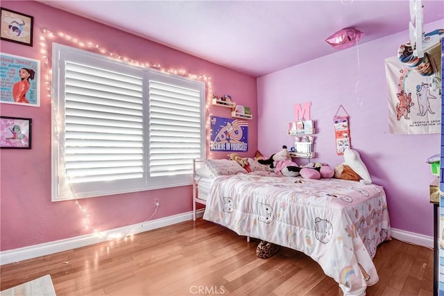 bedroom with hardwood / wood-style floors