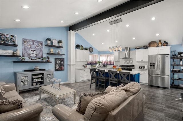 living room with dark hardwood / wood-style floors and vaulted ceiling with beams