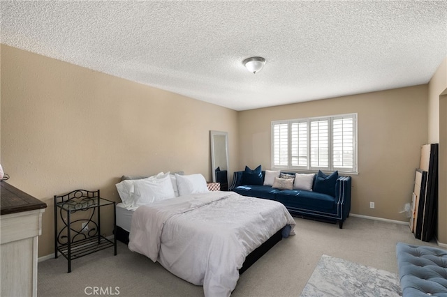 bedroom featuring a textured ceiling and light carpet