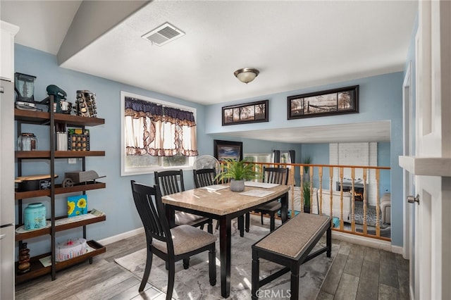 dining area with hardwood / wood-style flooring