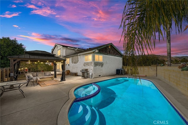 pool at dusk featuring central AC unit, a patio area, and a gazebo