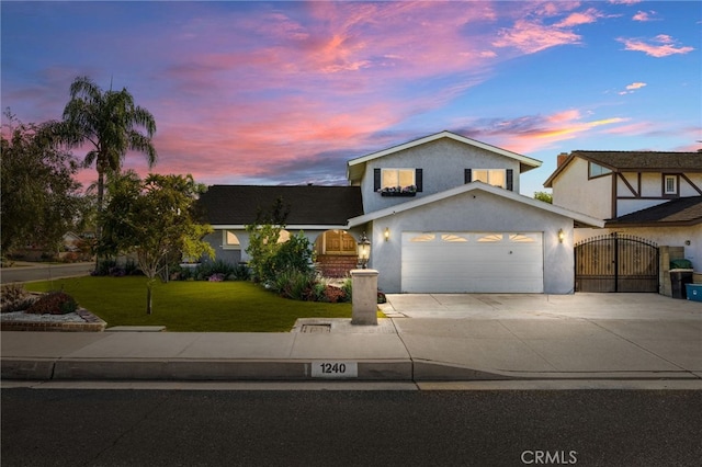 front of property featuring a yard and a garage