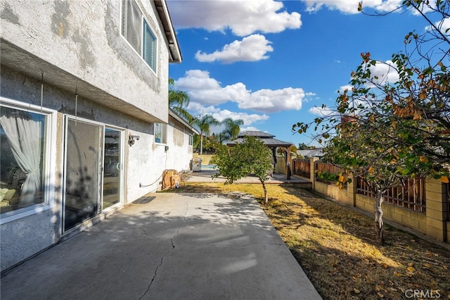 view of side of home with a patio area and a gazebo