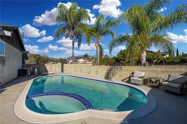 view of pool featuring an in ground hot tub and a patio area