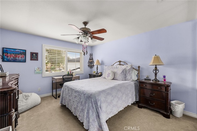 bedroom featuring ceiling fan and light carpet