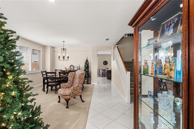 dining space featuring light tile patterned flooring and a chandelier