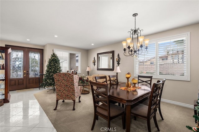 dining space with a chandelier and light tile patterned flooring