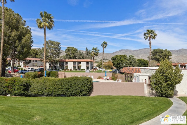 view of home's community with a lawn and a mountain view