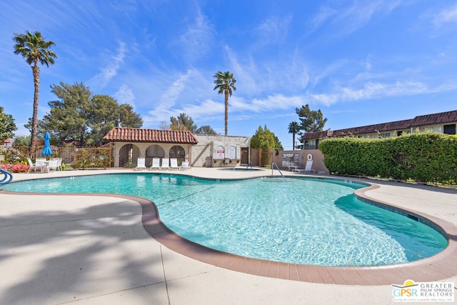 view of swimming pool with a patio