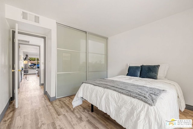 bedroom featuring a closet and wood-type flooring