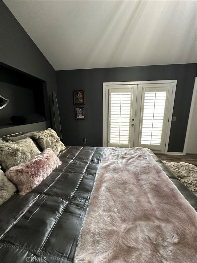 bedroom featuring french doors and lofted ceiling