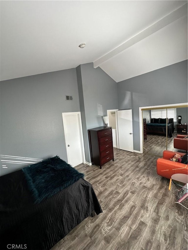 bedroom with high vaulted ceiling, visible vents, beamed ceiling, and wood finished floors