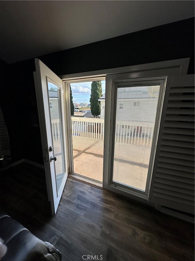 doorway to outside featuring dark wood-style floors