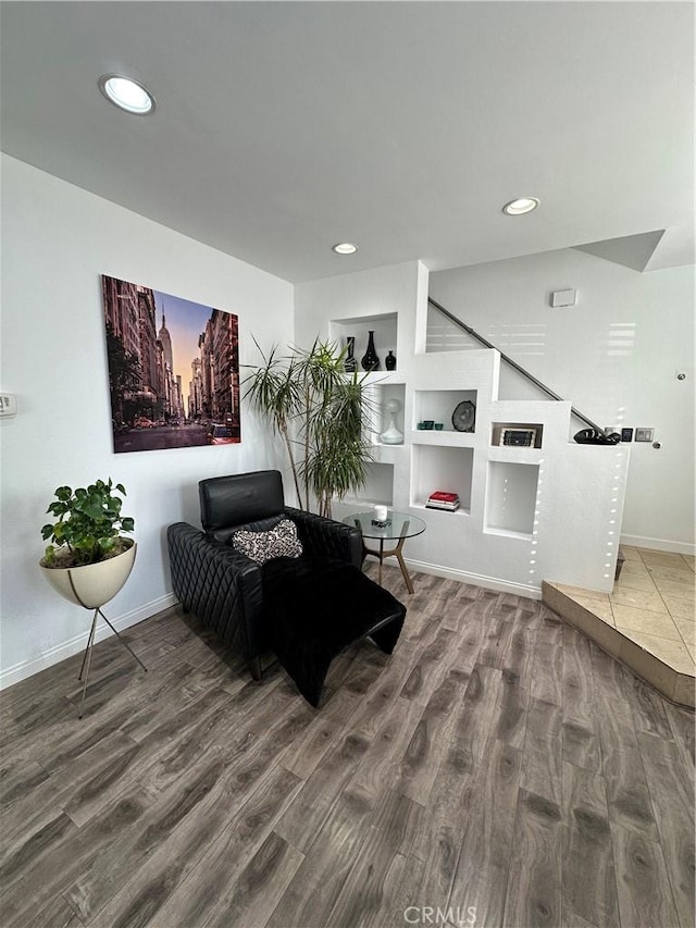 living area with wood finished floors, baseboards, and recessed lighting