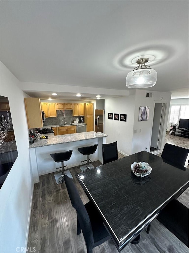 dining area featuring dark wood-type flooring