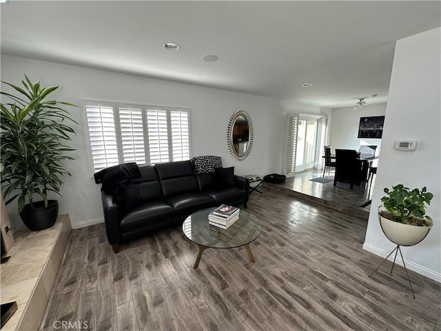 living room featuring plenty of natural light and dark hardwood / wood-style floors