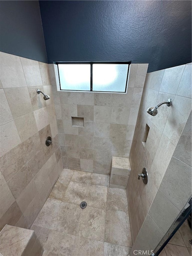 bathroom with a tile shower