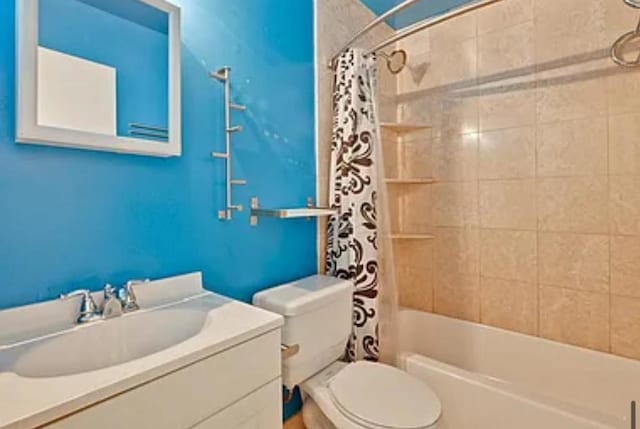 full bathroom featuring vanity, shower / bath combination with curtain, and toilet