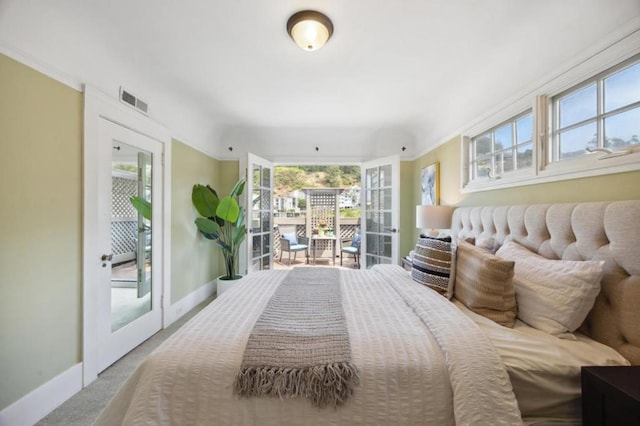 carpeted bedroom with access to outside and french doors