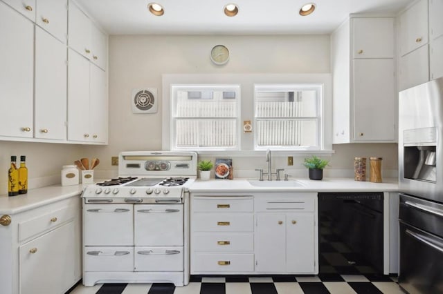 kitchen featuring double oven range, dishwasher, stainless steel fridge with ice dispenser, and white cabinets