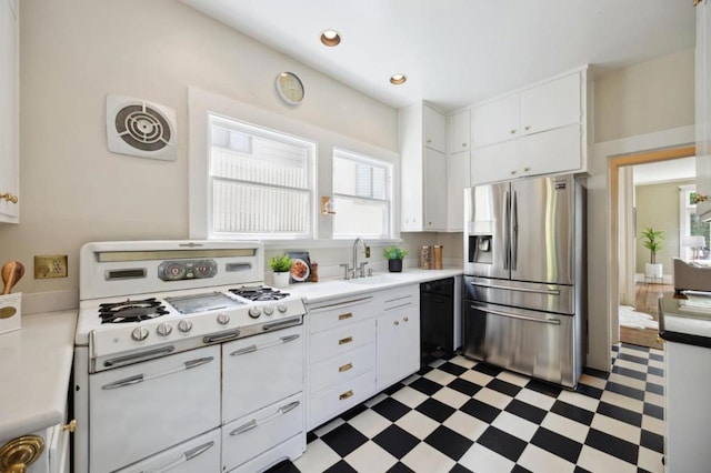 kitchen with sink, dishwasher, white cabinetry, double oven range, and stainless steel fridge with ice dispenser