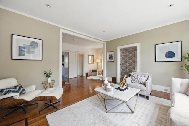 living room with hardwood / wood-style floors and crown molding