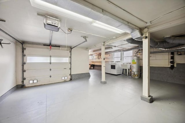 garage with washer and clothes dryer, sink, a garage door opener, and gas water heater