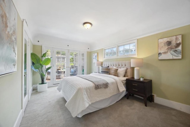 bedroom with french doors, light carpet, and access to outside