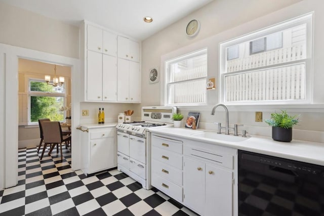 kitchen featuring double oven range, black dishwasher, sink, and white cabinets